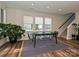 Bright dining room featuring large windows, wood floors, and a contemporary table setting at 306 Cloudcroft Aly, Charlotte, NC 28217