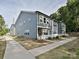 Exterior view of modern townhomes featuring gray siding, white fences, and well-maintained lawns at 306 Cloudcroft Aly, Charlotte, NC 28217