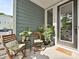 Charming covered front porch with seating and plants, creating a cozy entrance to the home at 306 Cloudcroft Aly, Charlotte, NC 28217