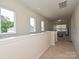Upstairs hallway filled with natural light from the large windows looking out over the neighborhood at 306 Cloudcroft Aly, Charlotte, NC 28217