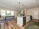 Modern kitchen with granite countertops, stainless steel appliances, and an island with pendant lighting at 306 Cloudcroft Aly, Charlotte, NC 28217