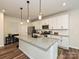 Modern kitchen with stainless steel appliances, granite countertops, and a large island perfect for meal preparation at 306 Cloudcroft Aly, Charlotte, NC 28217