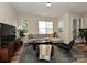 Bright living room featuring a comfortable gray sectional sofa, contemporary decor, and ample natural light at 306 Cloudcroft Aly, Charlotte, NC 28217