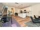 Open-concept living space with a spacious kitchen island, modern appliances, and stylish flooring for seamless entertaining at 306 Cloudcroft Aly, Charlotte, NC 28217