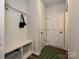 Functional mudroom with built-in storage, bench seating, and convenient coat hooks at 306 Cloudcroft Aly, Charlotte, NC 28217