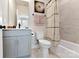 Well-lit bathroom with a combination tub and shower, and gray vanity at 316 S Turner Ave # 11, Charlotte, NC 28208