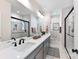 Modern bathroom featuring dual sinks, sleek black fixtures, and a glass-enclosed shower at 316 S Turner Ave # 11, Charlotte, NC 28208