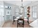 Bright dining area with a glass table, modern light fixture, and views of plants at 316 S Turner Ave # 11, Charlotte, NC 28208
