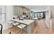 Kitchen with stainless steel appliances, a kitchen island, and bar seating overlooking the living area at 316 S Turner Ave # 11, Charlotte, NC 28208