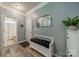 Hallway features a bench, mirror, and access to the bathroom and front door at 3205 Berry Creek Rd, Charlotte, NC 28214