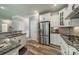 Updated kitchen with granite countertops, stainless steel appliances, and white cabinetry at 3205 Berry Creek Rd, Charlotte, NC 28214