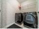 Laundry room featuring modern appliances and stylish wallpaper at 3205 Berry Creek Rd, Charlotte, NC 28214