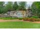 Entrance sign for 'The Rapids at Belmeade' surrounded by lush landscaping and colorful flowers at 3205 Berry Creek Rd, Charlotte, NC 28214