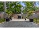 Outdoor grilling area with a barbecue and mature trees in the backyard, providing a delightful cooking and dining experience at 3538 Denson Pl, Charlotte, NC 28215
