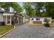 Spacious backyard with a gravel area, a cozy deck, and a well-maintained lawn for outdoor activities at 3538 Denson Pl, Charlotte, NC 28215