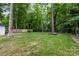 Lush backyard with mature trees, manicured lawn, and minimal landscaping creates a serene and natural setting at 3538 Denson Pl, Charlotte, NC 28215