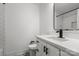 Bathroom includes vanity with white countertop, black fixtures, square mirror, and contrasting tile flooring at 3538 Denson Pl, Charlotte, NC 28215