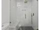 Updated bathroom offers modern tiling, a glass shower enclosure, and a sleek floating vanity with storage at 3538 Denson Pl, Charlotte, NC 28215