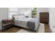 Cozy bedroom with warm wood floors, dresser and night stands, and natural light for a comfortable vibe at 3538 Denson Pl, Charlotte, NC 28215