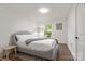 Well-lit bedroom offering a cozy rug and natural light provides a relaxing and stylish personal space at 3538 Denson Pl, Charlotte, NC 28215