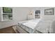 Bright bedroom features natural light with two windows that complement the neutral tones and simple decor at 3538 Denson Pl, Charlotte, NC 28215