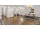 Bright dining room with hardwood floors, a large mirror, and a view of the entry at 3538 Denson Pl, Charlotte, NC 28215