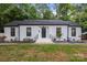 Charming single-story home featuring a painted brick facade, dark trim, and well-maintained landscaping at 3538 Denson Pl, Charlotte, NC 28215
