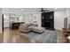 Open-concept living room connects to the kitchen and has hardwood floors and a fireplace at 3538 Denson Pl, Charlotte, NC 28215