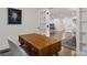 Stylish home office with wooden desk, natural light, and doorway leading to the open-concept living area at 3538 Denson Pl, Charlotte, NC 28215