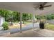Charming covered patio with ceiling fan, lounge seating, and backyard access at 3538 Denson Pl, Charlotte, NC 28215
