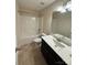 Bathroom featuring a combined shower and tub, plus a vanity with ample counter space at 4048 Avis Way, Monroe, NC 28110