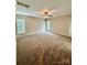 Spacious bedroom featuring plush carpeting, a ceiling fan, and bright windows at 4048 Avis Way, Monroe, NC 28110