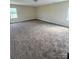 Bedroom showcases neutral paint, carpet, and natural lighting at 4048 Avis Way, Monroe, NC 28110