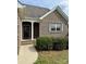 A welcoming front entrance framed by white columns and complemented by manicured shrubbery at 4048 Avis Way, Monroe, NC 28110