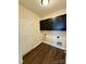 Functional laundry room features wood flooring and cabinetry with ample storage space at 4048 Avis Way, Monroe, NC 28110