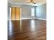 Spacious living room with dark wood floors and natural light streaming through the windows at 4048 Avis Way, Monroe, NC 28110
