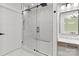 Luxurious bathroom featuring glass shower enclosure, white marble and a wood vanity at 4135 Mineral Ln, Lincolnton, NC 28092