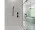 Modern bathroom featuring white marble tile and a frameless glass shower with black hardware at 4135 Mineral Ln, Lincolnton, NC 28092