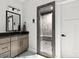 Bathroom featuring gray vanity, glass shower with bench seating, and large mirror at 4135 Mineral Ln, Lincolnton, NC 28092
