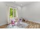 Bright, minimalist bedroom with hardwood floors and a large window at 4135 Mineral Ln, Lincolnton, NC 28092