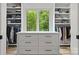 Custom walk-in closet featuring a center island dresser with a large window and built in shelving at 4135 Mineral Ln, Lincolnton, NC 28092