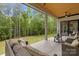 Covered patio features comfortable seating and a wooded view at 4135 Mineral Ln, Lincolnton, NC 28092