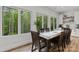 Bright dining room with large windows offering wooded views and a large wooden dining table at 4135 Mineral Ln, Lincolnton, NC 28092