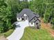 An aerial view showcases a modern home surrounded by lush greenery and a large front lawn at 4135 Mineral Ln, Lincolnton, NC 28092
