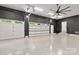 Spacious three car garage featuring epoxy flooring, painted walls, and modern lighting at 4135 Mineral Ln, Lincolnton, NC 28092