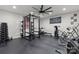 Home gym featuring rubber flooring, weight rack, exercise equipment, and custom signage at 4135 Mineral Ln, Lincolnton, NC 28092