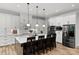 Modern kitchen features a spacious island with seating and white cabinets with stainless steel appliances at 4135 Mineral Ln, Lincolnton, NC 28092