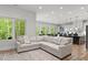 Open-concept living room boasts a large sectional sofa, and views of the wooded outdoors at 4135 Mineral Ln, Lincolnton, NC 28092