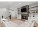 Inviting living room featuring a stone fireplace, floating shelves, and comfortable seating at 4135 Mineral Ln, Lincolnton, NC 28092