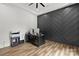 Office featuring dark herringbone accent wall and hardwood floors at 4135 Mineral Ln, Lincolnton, NC 28092